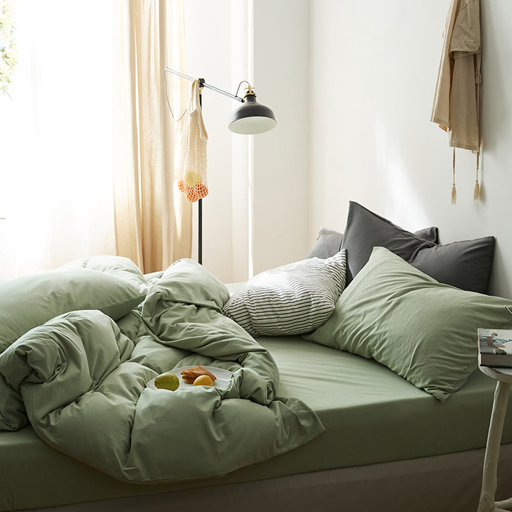 Side view of the VibeCore Aesthetic Solid Comfort Duvet Cover Set in Sage, showcasing its soft, breathable fabric and soothing green hue that adds a calming touch to your bedroom or dorm.