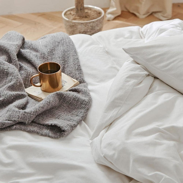 The "VibeCore Aesthetic Solid Comfort Duvet Cover Set in White" showcases a flawless, smooth texture that exudes simplicity and elegance. The clean, crisp white fabric provides a serene atmosphere, while the breathable material ensures ultimate comfort. Perfect for creating a minimalist, fresh vibe in your bedroom, this duvet cover set brings a touch of luxury and peaceful restfulness to your space.
