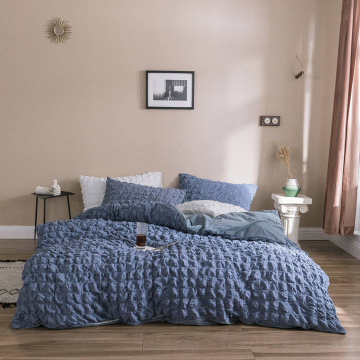 Add a soft, luxurious touch to your bedroom with the VibeCore Aesthetic Tufted Duvet Cover Set in blue. Featuring a plush tufted design, this duvet offers a cozy yet stylish look. The aerial view captures the intricate pattern, highlighting the texture and warmth of the premium fabric. Perfect for a serene, chic ambiance.
