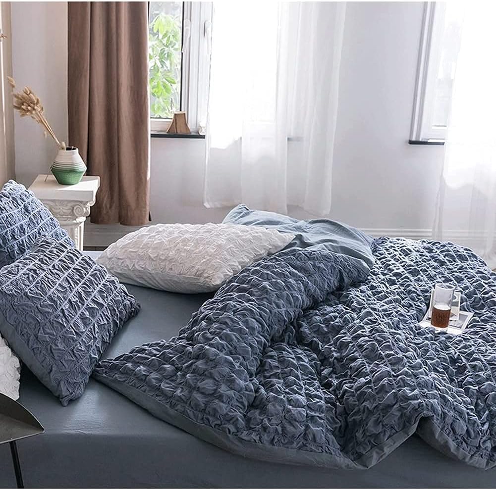Transform your bedroom into a serene sanctuary with the VibeCore Aesthetic Tufted Duvet Cover Set in blue. From the side view, the gentle tufting detail and rich color create a calming vibe, perfect for a relaxing space. The soft, breathable fabric ensures maximum comfort, making it the ideal choice for a chic and cozy sleep environment. Elevate your decor with a timeless design that exudes tranquility.