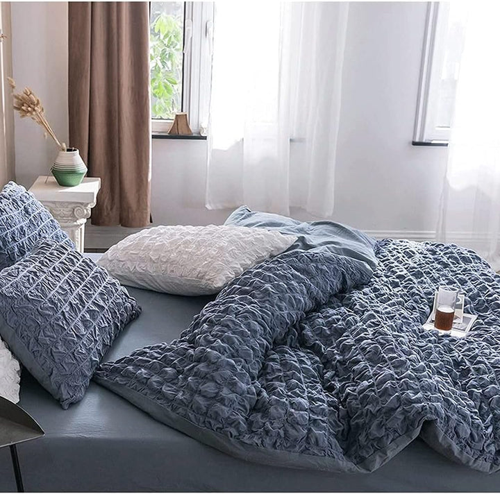 Transform your bedroom into a serene sanctuary with the VibeCore Aesthetic Tufted Duvet Cover Set in blue. From the side view, the gentle tufting detail and rich color create a calming vibe, perfect for a relaxing space. The soft, breathable fabric ensures maximum comfort, making it the ideal choice for a chic and cozy sleep environment. Elevate your decor with a timeless design that exudes tranquility.