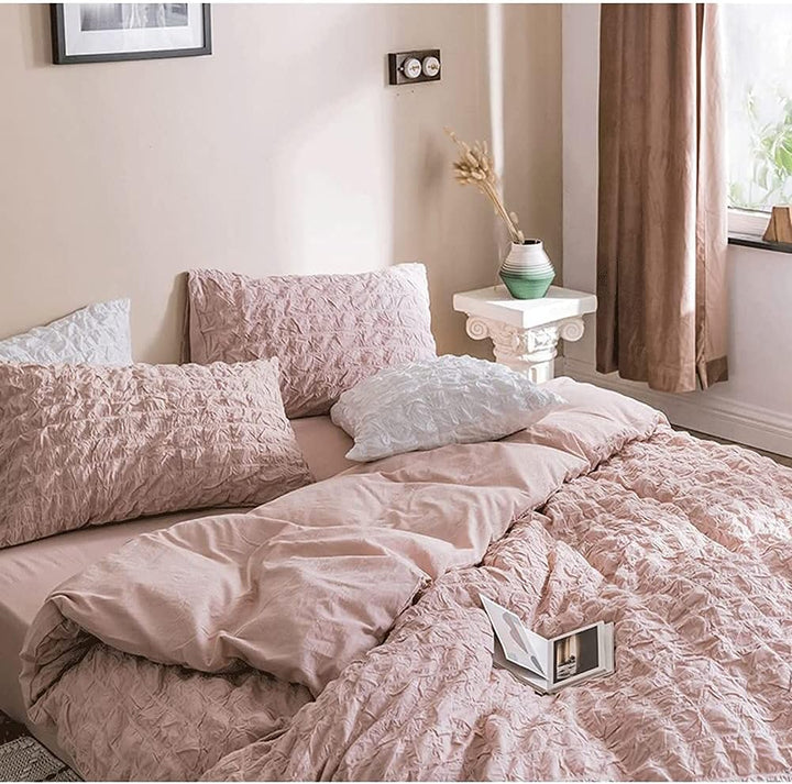 Experience effortless elegance with the VibeCore Aesthetic Tufted Duvet Cover Set in rose. From the angled aerial view, the intricate tufted design and soft, plush texture bring a sense of comfort and style to your space. The gentle rose hue adds a touch of warmth and sophistication, making this duvet cover set the perfect centerpiece for a chic, cozy bedroom.