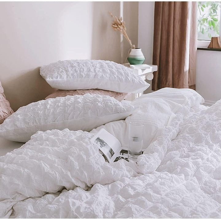 Discover the elegant texture of the VibeCore Aesthetic Tufted Duvet Cover Set in white. This close-up reveals the soft, tufted details that provide both visual charm and a plush, luxurious feel. Crafted with premium materials, the duvet cover offers an inviting and cozy atmosphere, adding a timeless, sophisticated touch to any bedroom or dorm decor.