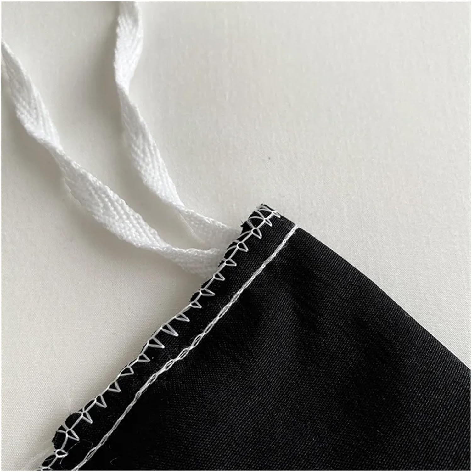 Detailed close-up of the stitching on the VibeCore Aesthetic Tufted Floral Pattern Duvet Cover Set in black, highlighting the high-quality craftsmanship and delicate stitching that enhances the textured, tufted floral design for a refined and cozy finish.
