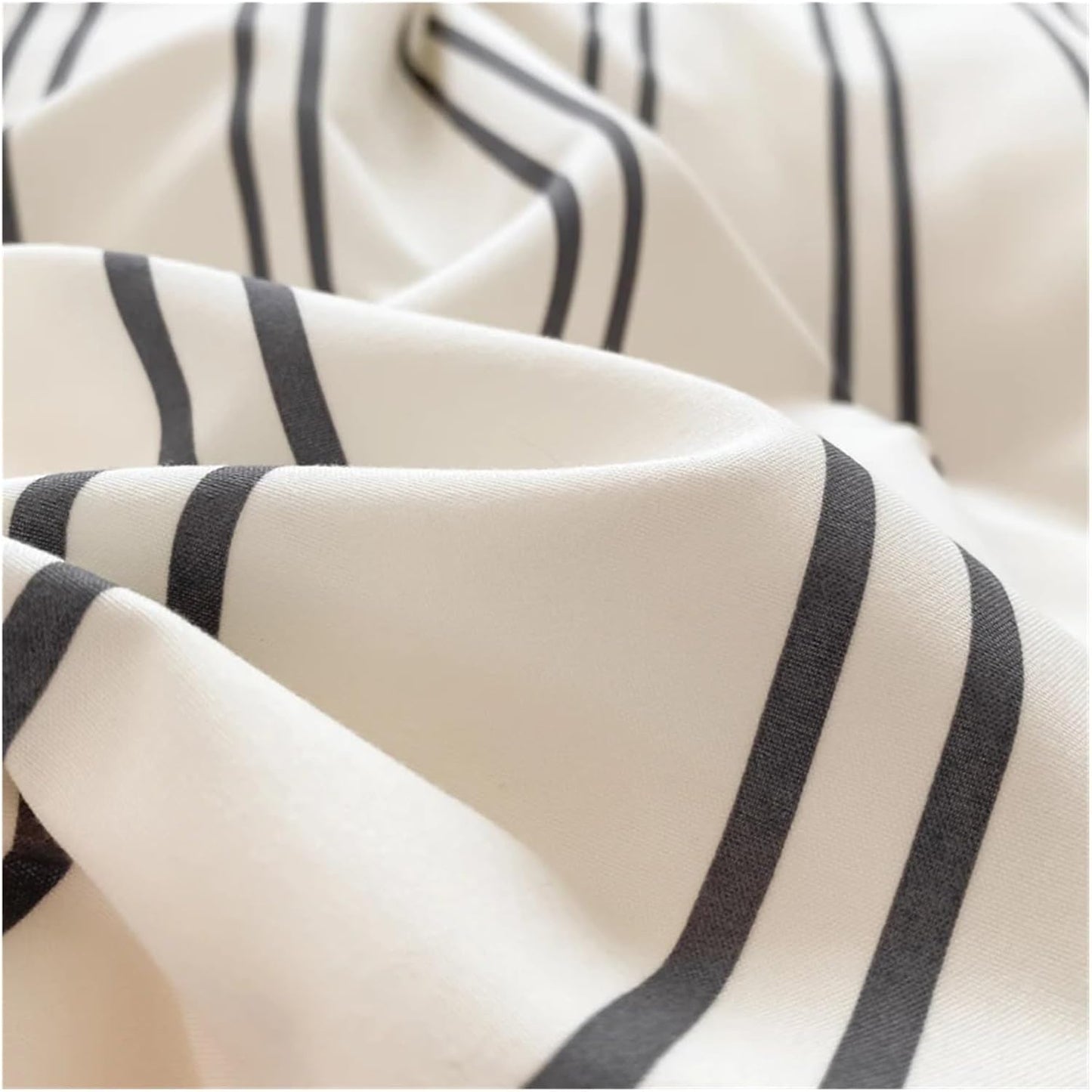Super close-up of the black stripe pattern on a white backdrop on the 'VibeCore Urban Stripe Bedding Set,' highlighting the sharp, clean lines and soft texture of the fabric. The minimalist design offers a stylish, modern aesthetic for any bedroom.