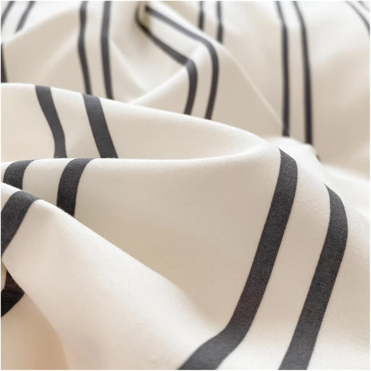 Super close-up of the black stripe pattern on a white backdrop on the 'VibeCore Urban Stripe Bedding Set,' highlighting the sharp, clean lines and soft texture of the fabric. The minimalist design offers a stylish, modern aesthetic for any bedroom.