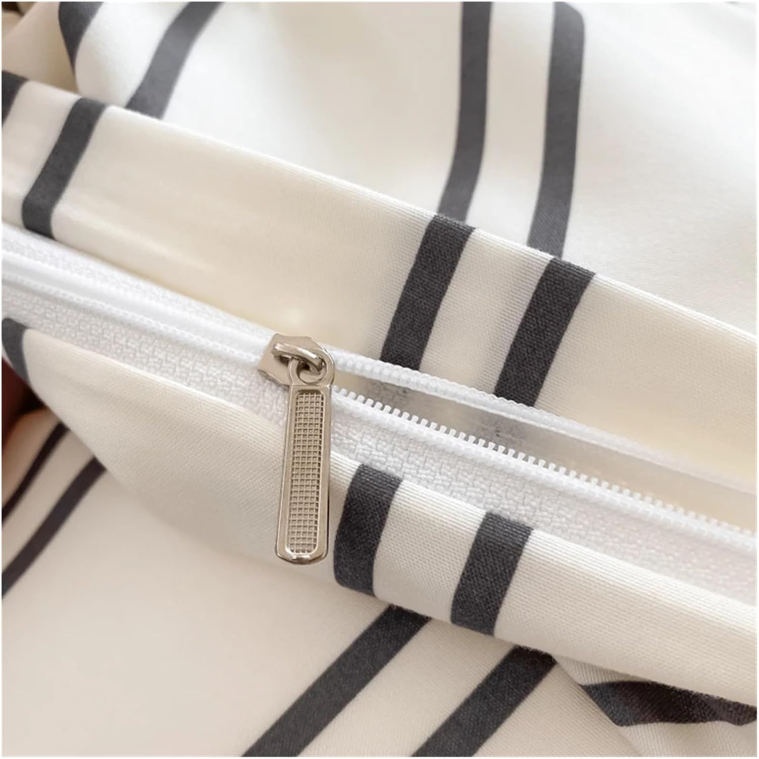 Close-up of the zipper on the 'VibeCore Urban Stripe Bedding Set,' showcasing its sleek, functional design. The durable zipper adds a practical yet stylish touch to the bedding, ensuring easy use and a polished finish.