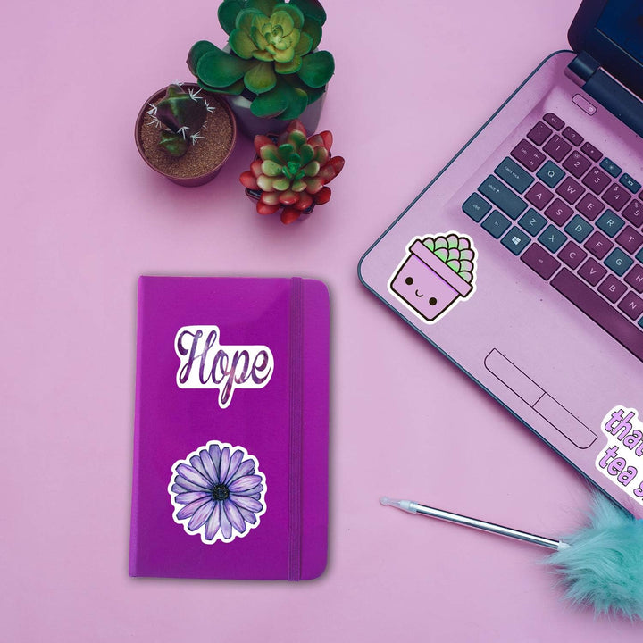 VibeCore All Things Purple Stickers on a notebook and laptop, featuring vibrant purple aesthetic designs, trendy purple stickers, and unique purple decals for customization.