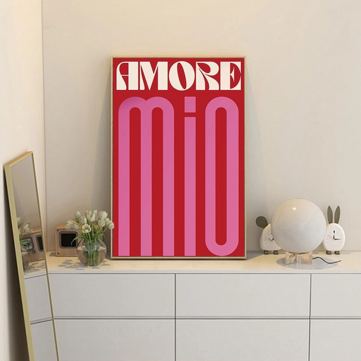 "Amore Mio" canvas poster framed and displayed on a dresser, featuring vintage Italian-inspired typography in red, pink, and white. Adds a romantic, Parisian café vibe to bedroom or dorm decor. Printed on premium cotton canvas for vibrant, long-lasting color.