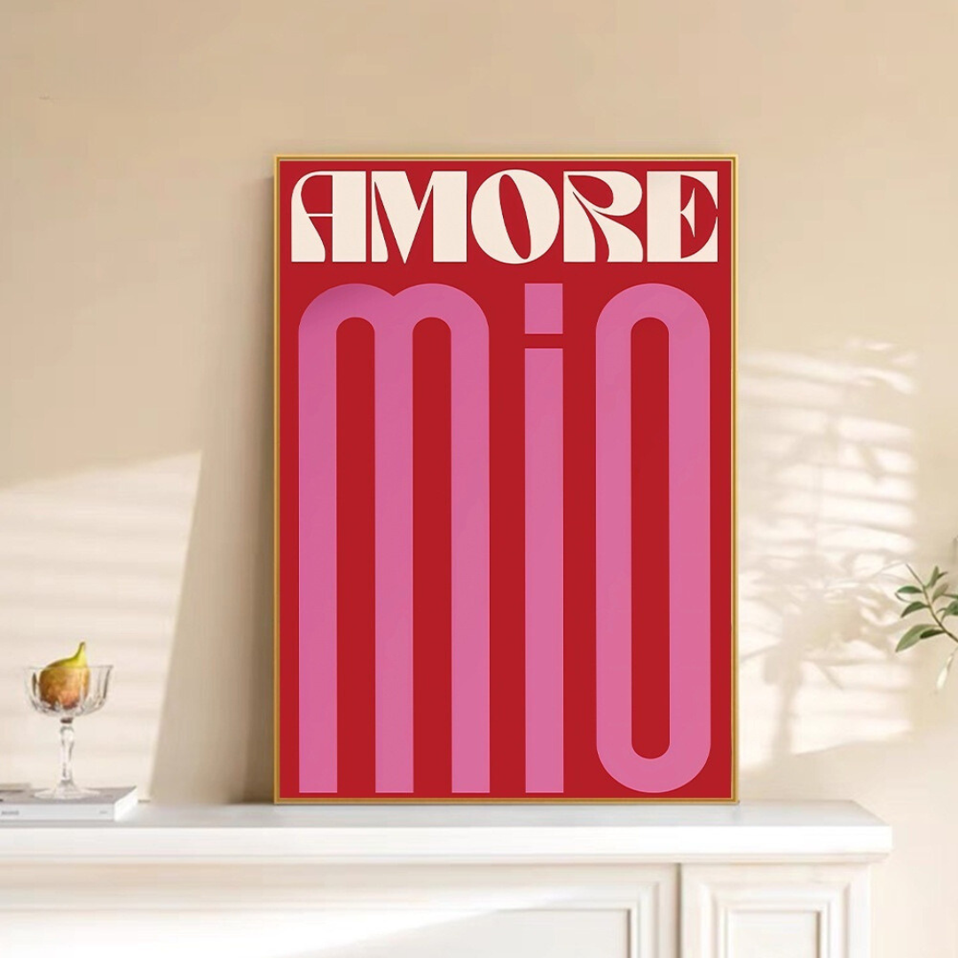 "Amore Mio" canvas poster framed and displayed above a fireplace, featuring vintage Italian-inspired typography in red, pink, and white. This romantic wall art adds a cozy, Parisian café feel to any living room or bedroom. Printed on premium cotton canvas for lasting vibrancy.