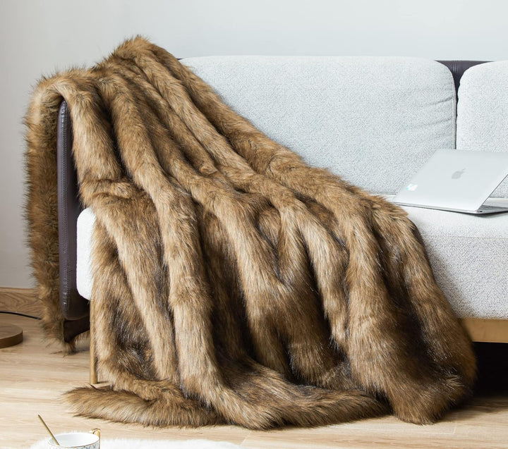 Brown Arctic Dream Faux Fur Throw Blanket draped over a couch, adding a luxurious, European-inspired touch. Soft, plush, and perfect for creating a warm, elegant atmosphere in your living room.