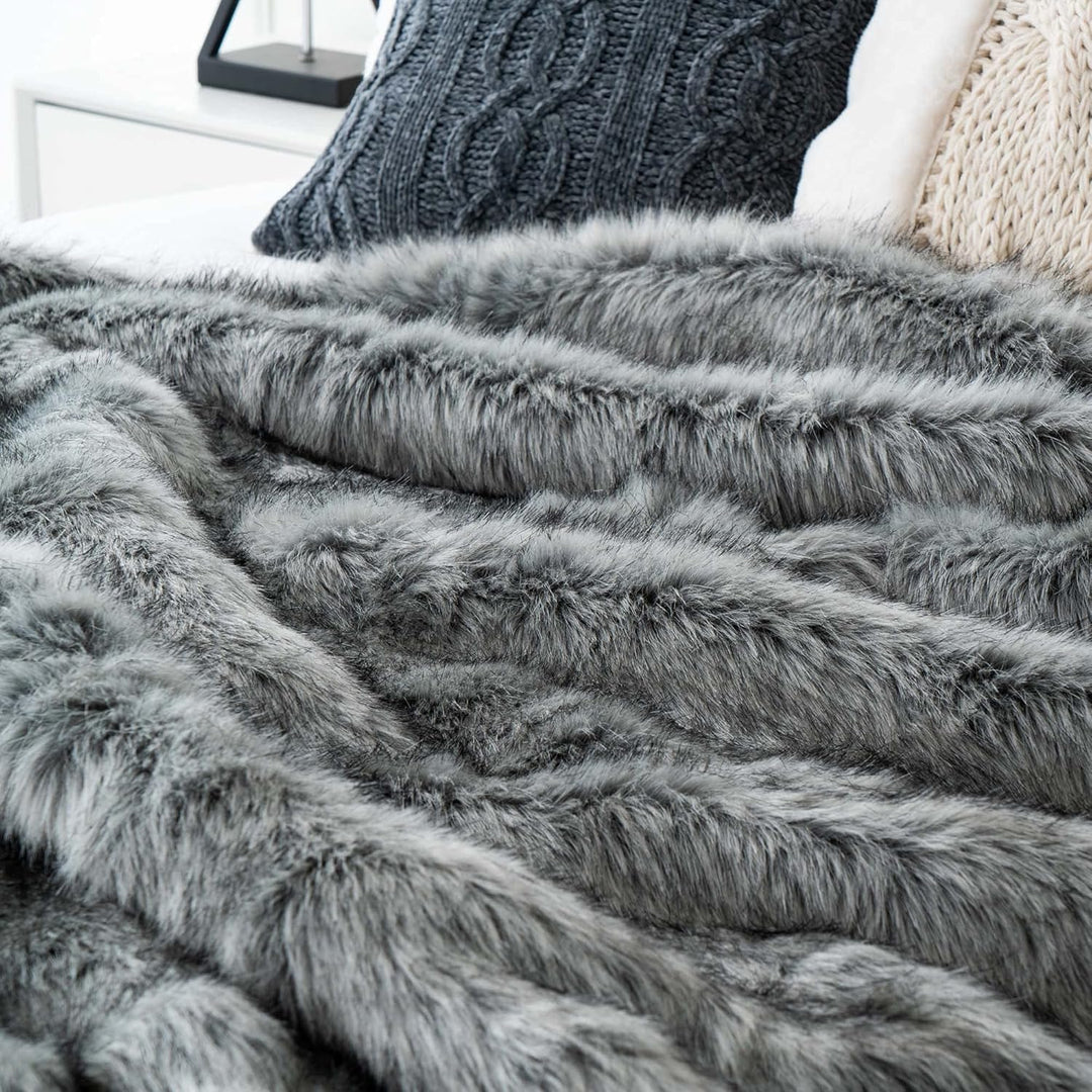 Close-up of a gray Arctic Dream Faux Fur Throw Blanket, showcasing its soft, plush texture and luxurious, European-inspired design. A cozy and elegant addition to any space.
