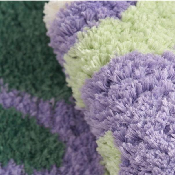 Close-up of the VibeCore Aubergine Accent Rug, showcasing its soft plush texture, vibrant purple color, and high-quality material for a cozy and stylish touch.