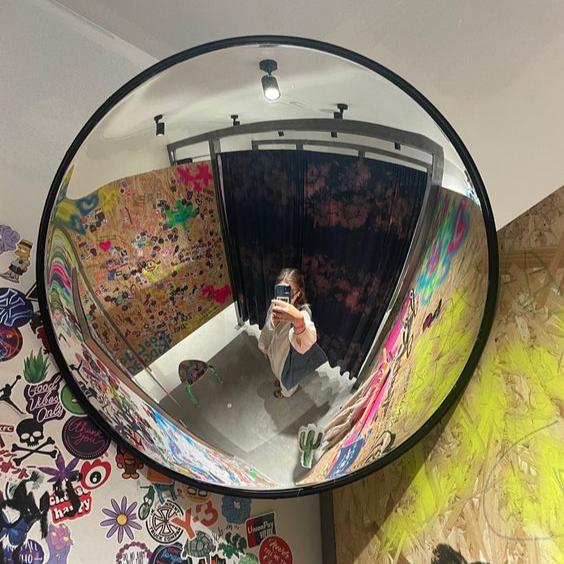 VibeCore Black Convex Traffic Mirror in change room, featuring a bold black frame and wide-angle lens. This grunge-inspired convex mirror offers a unique fish-eye view, enhancing visibility and adding an urban, retro vibe. Perfect for modern change room decor, it combines style and function with a sleek, industrial flair.