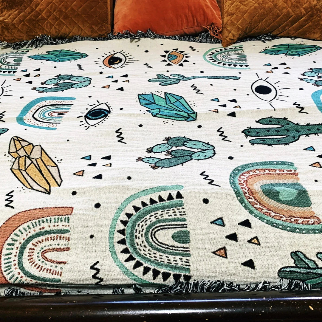 Close-up of the VibeCore Cactus & Crystals Woven Blanket, showcasing its intricate cactus and crystal pattern with soft, detailed cotton weave for a vibrant, earthy design.