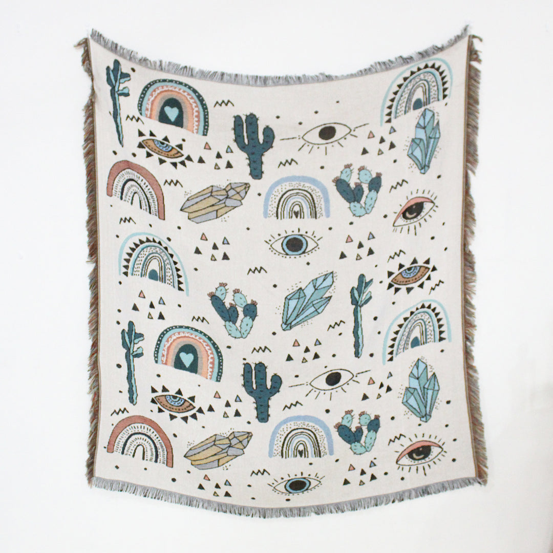 VibeCore Cactus & Crystals Woven Blanket laid flat to display its earthy cactus and crystal design, highlighting the soft, reversible cotton texture and vibrant patterns.