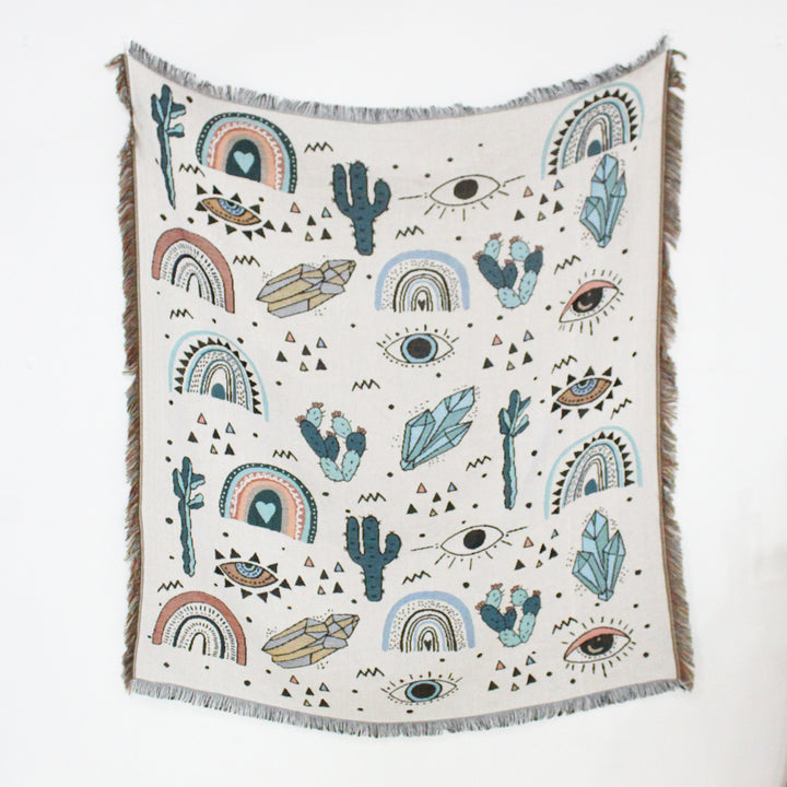 VibeCore Cactus & Crystals Woven Blanket laid flat to display its earthy cactus and crystal design, highlighting the soft, reversible cotton texture and vibrant patterns.