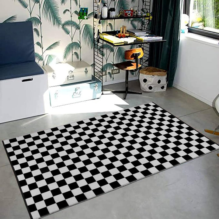 VibeCore Checkerboard Area Rug in Black on the floor, featuring a bold black and white checkerboard pattern that adds a modern, stylish touch to the space.