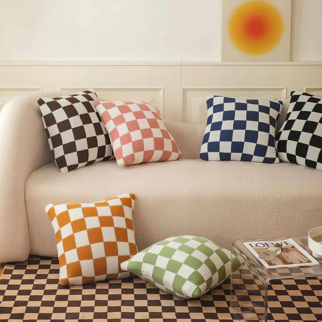 VibeCore Checkerboard Throw Pillow Covers in all colors, shown from an alternative angle on a couch. Bold checkerboard pattern with a plush polyester-cotton blend, enhancing your space with modern style and comfort.