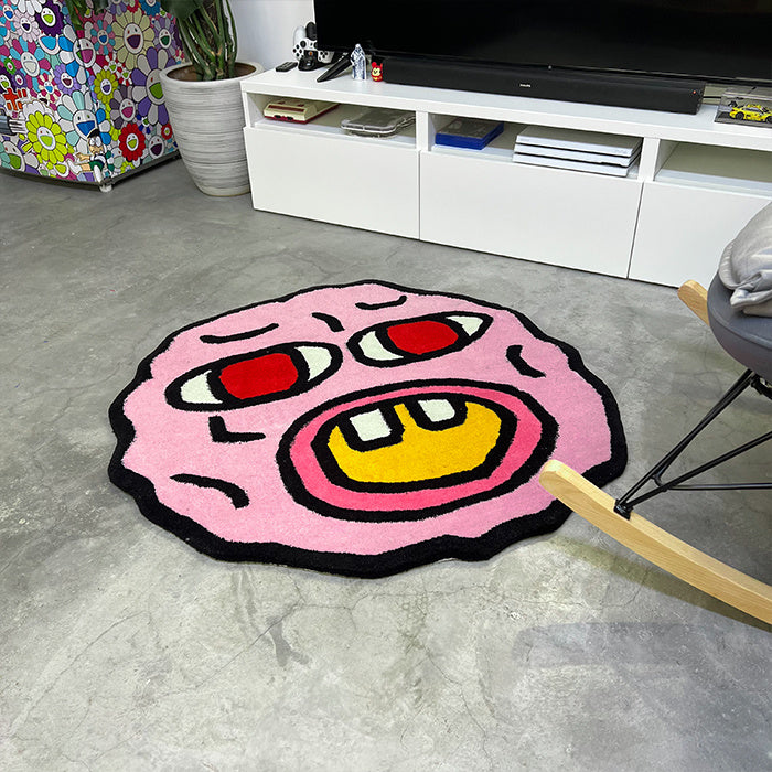 VibeCore Cherry Bomb Accent Rug aerial side view, showcasing vibrant Tyler The Creator-inspired design. This round rug adds bold color and unique personality, perfect for bedrooms, dorms, apartments, modern spaces, urban style, and playful aesthetic. Features soft texture, non-slip backing, and a contemporary vibe.