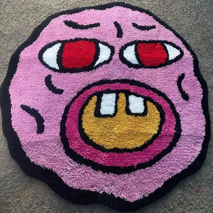 Close-up of the VibeCore Cherry Bomb Accent Rug, highlighting its vibrant Tyler The Creator-inspired design. This soft, round rug features bold colors, intricate details, and a plush texture, perfect for adding personality and style to any room, from bedrooms to dorms.