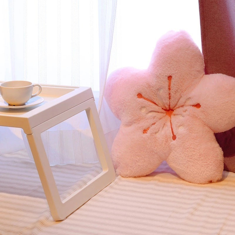 VibeCore Cherry Petal Throw Pillow in baby pink on a bed, featuring a playful floral design made from soft plush PP cotton. A fresh, spring-inspired accent that adds a cozy pop of color and charm to your bedroom decor.