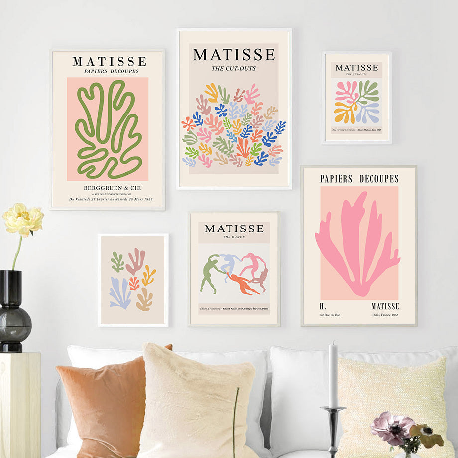 A chic and colorful "VibeCore Colorful Matisse Canvas Poster" collage displayed on a living room wall. The vibrant pastel prints feature iconic Matisse papiers découpés and abstract figure designs, bringing a modern, artistic flair to the space. These bold yet elegant artworks create a contemporary, gallery-like atmosphere, perfect for adding personality to your living room or aesthetic decor.