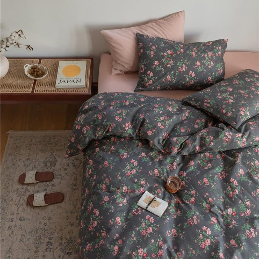 Aerial close-up of the VibeCore Cottagecore Black Floral Duvet Cover Set, showcasing intricate black floral patterns on soft fabric, adding a vintage-inspired, cozy touch to your bedroom or dorm decor.