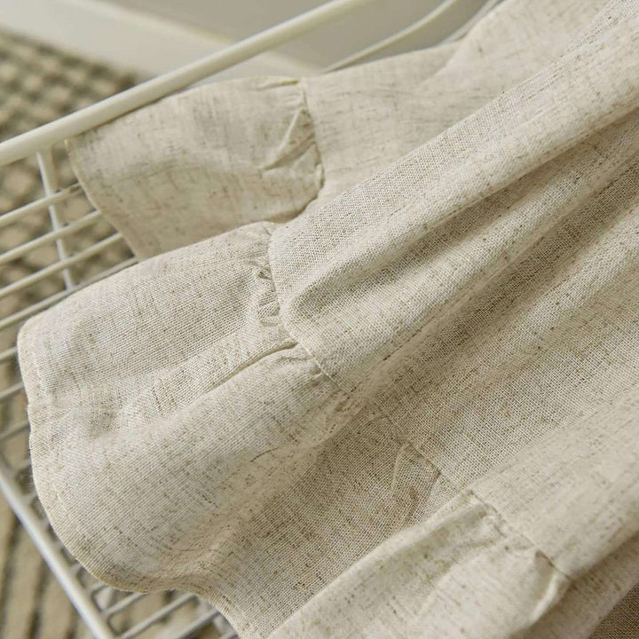 Close-up of the bottom ruffle detail on the VibeCore Delicate Ruffles Curtain in beige, highlighting the soft, layered fabric.