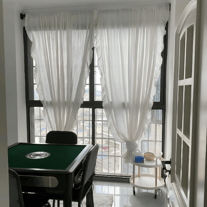 VibeCore Delicate Ruffles Curtain in white hanging in a bright apartment, creating a soft, bohemian atmosphere with its semi-sheer fabric and ruffle detailing.