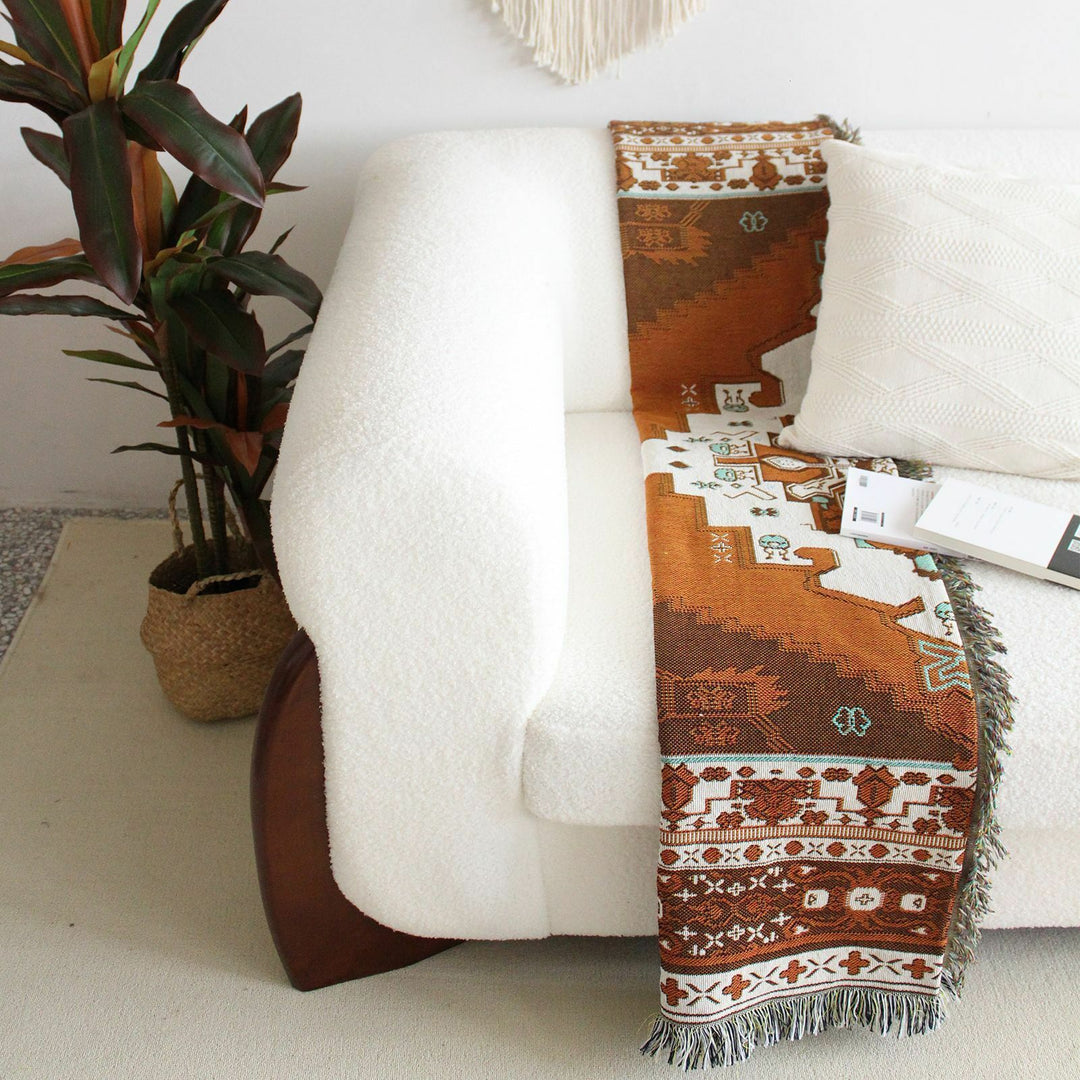 VibeCore Desert Mirage Woven Blanket folded on couch - soft reversible boho cotton throw with tribal pattern for cozy living room decor