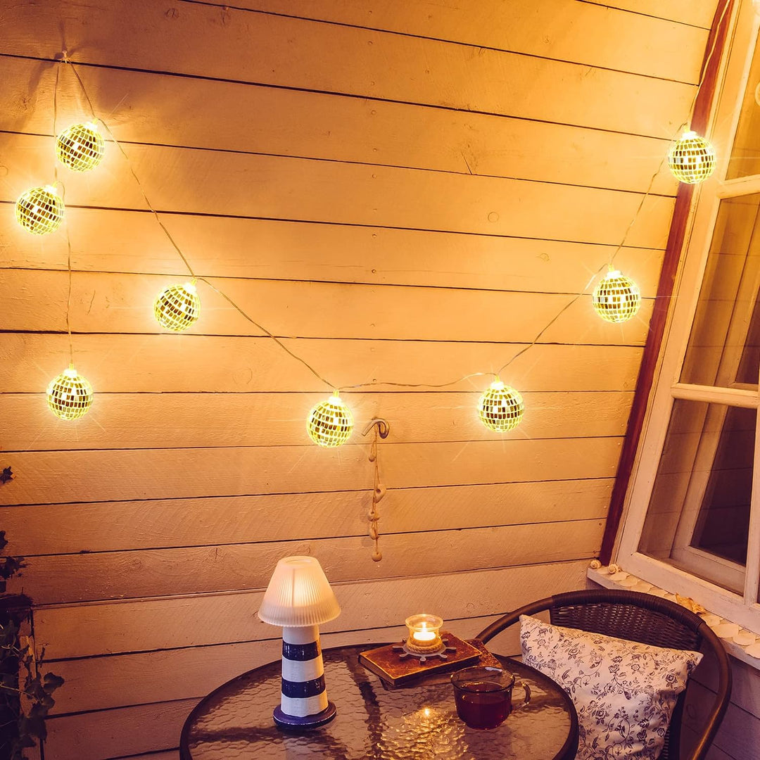VibeCore Disco Ball String Lights hanging outside, with small reflective disco balls glowing in warm white light, creating a vibrant and fun ambiance.