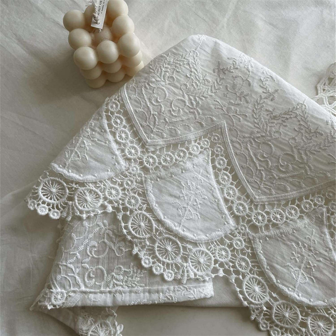 VibeCore French White Lace Tablecloth lace detail close up, intricate anemone lace pattern, vintage French aesthetic, elegant cotton tablecloth texture.