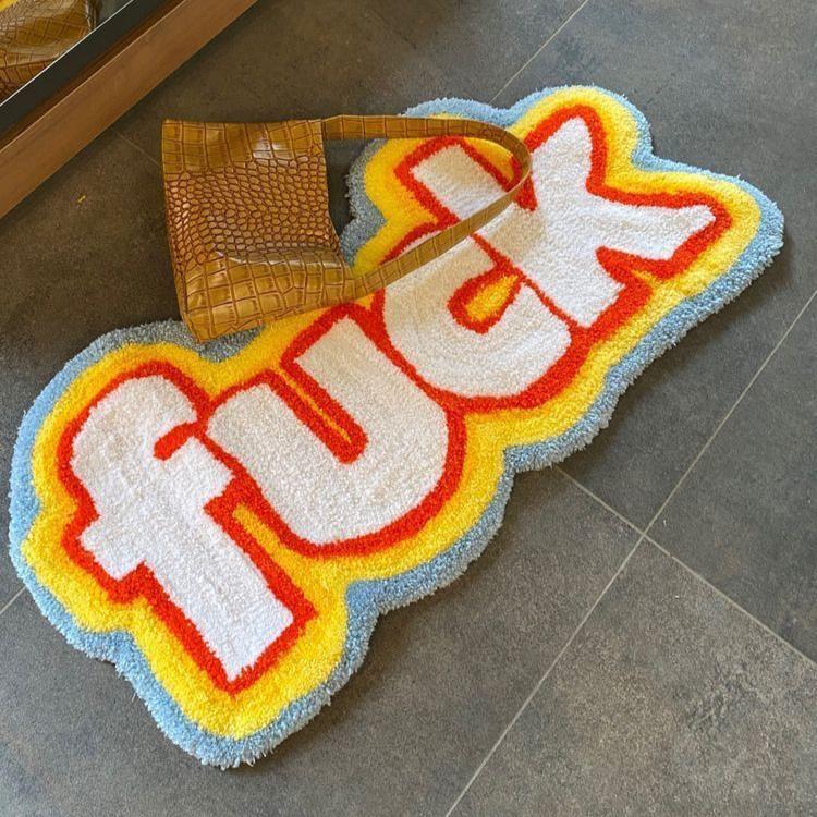 VibeCore Fuck Accent Rug featuring bold text and an edgy design, adding a rebellious touch to any room's decor. This rug combines comfort and attitude, with a non-slip backing for safety and easy maintenance. Perfect for high-traffic areas or adding personality to your space.