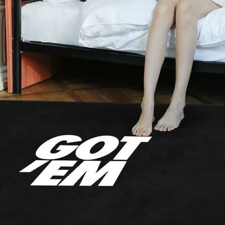 VibeCore Got 'Em Accent Rug in black with a girl sitting on the rug, showcasing its bold, sleek Euro-American style. Soft, fluffy texture with a non-slip backing, perfect for adding comfort and style to any space. Durable and easy to clean.