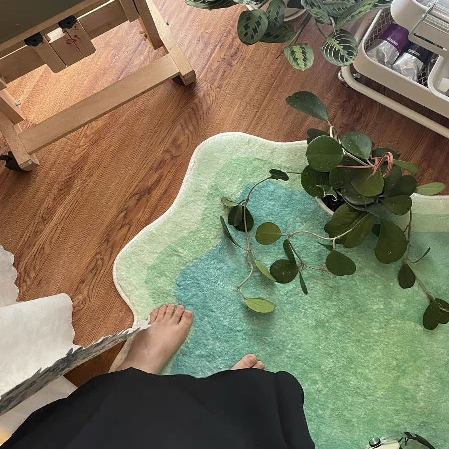 The VibeCore Gradient Wave Accent Rug in green with a person standing on it, showcasing the plush texture and dynamic gradient design. The rug adds a stylish, modern touch to any space while offering comfort underfoot.