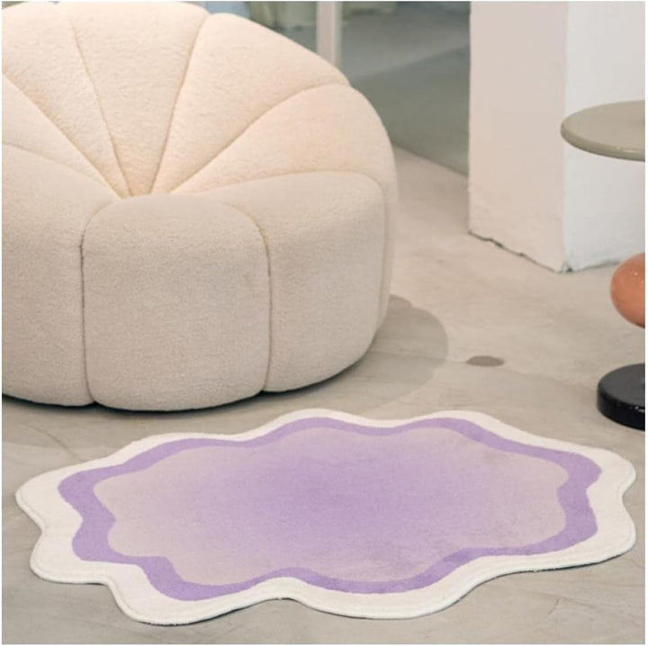 The VibeCore Gradient Wave Accent Rug in purple displayed on the floor, showcasing its fluid gradient design. The soft texture of the rug adds comfort and style to the space, enhancing the modern, dynamic vibe of the room.