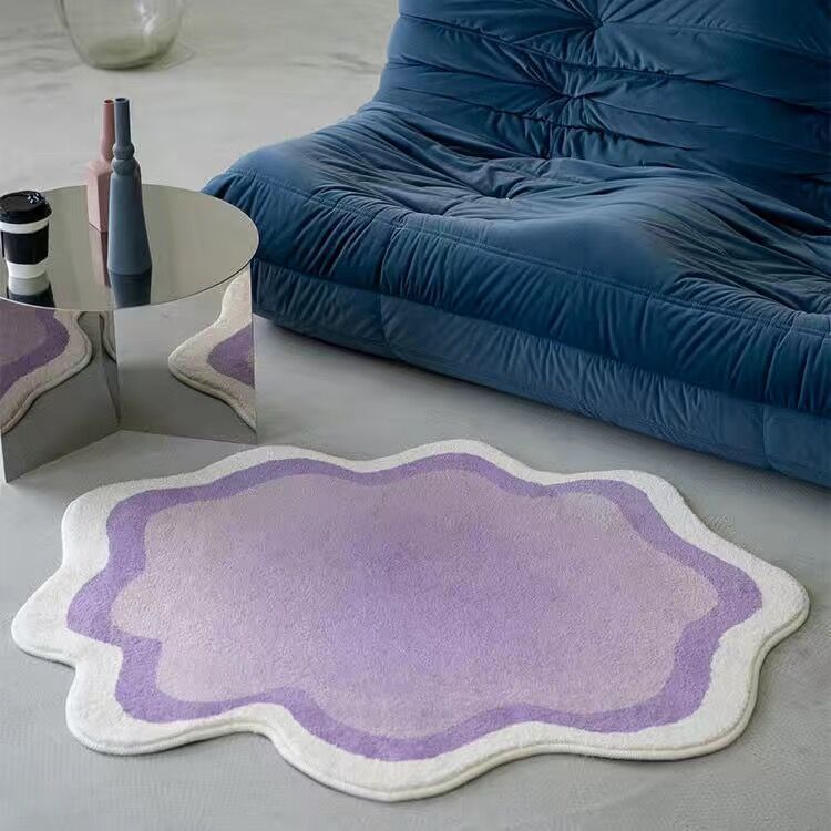 The VibeCore Gradient Wave Accent Rug in purple, elegantly placed on the living room floor. The fluid gradient design adds a modern touch to the space, blending seamlessly with the decor while providing a plush and comfortable feel underfoot.