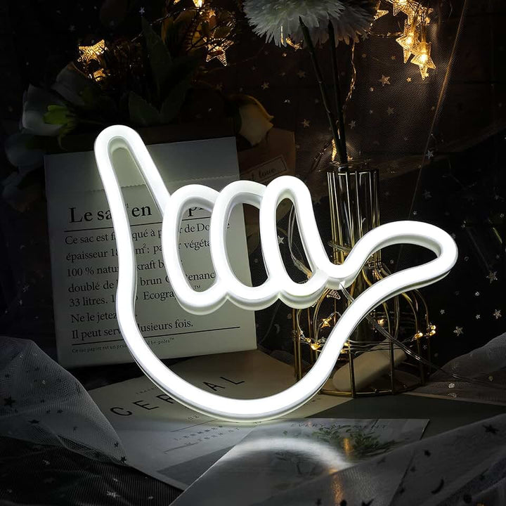 Aesthetic VibeCore Hang Loose Neon Light on a table, USB-powered LED sign for trendy bedroom, dorm, or lounge decor, adding a cool, laid-back glow to enhance your space with a relaxed, beachy vibe.