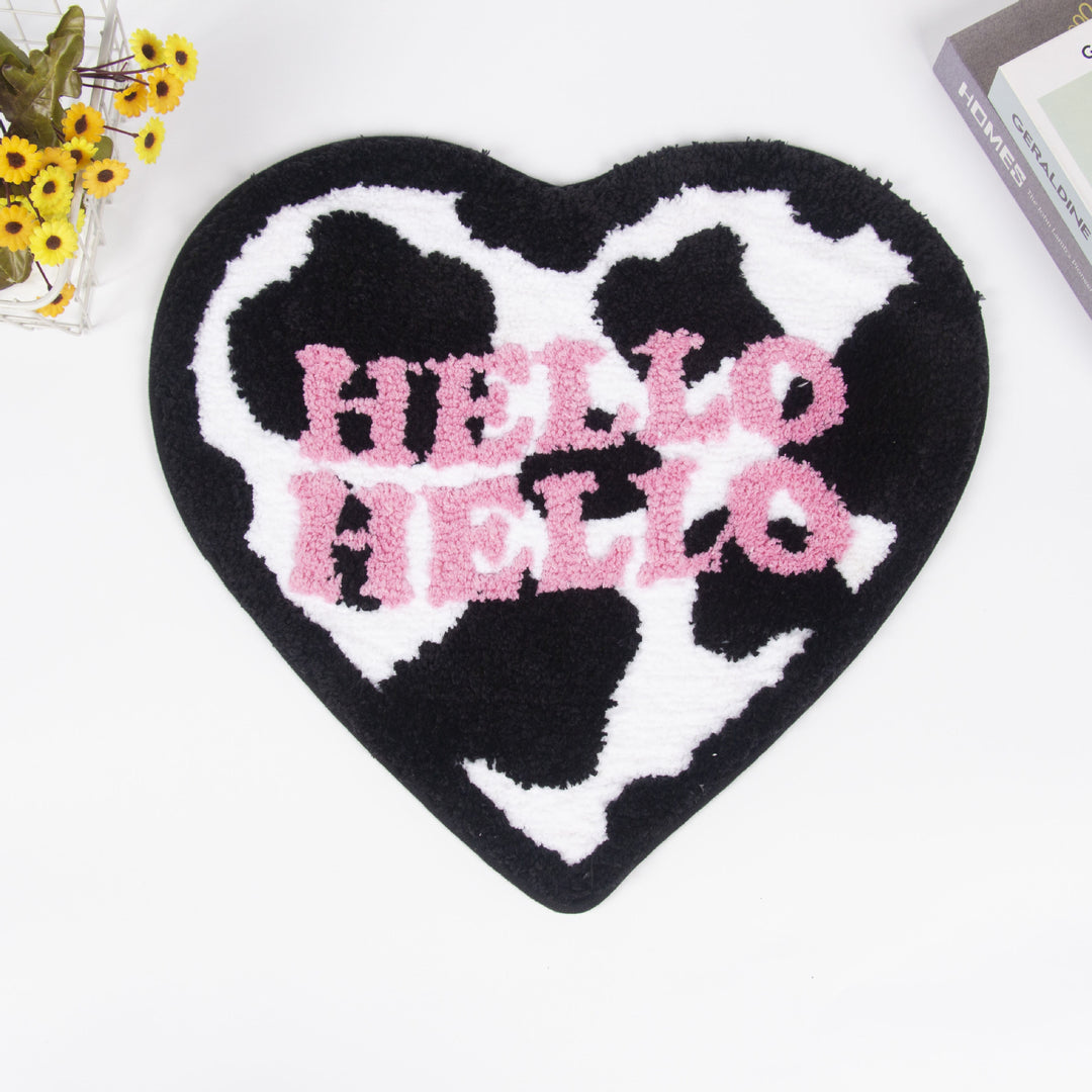 Aerial view of the VibeCore Hello Hello Cow-Print Heart Rug, showcasing its unique cow-print heart design and soft, plush texture, adding a fun and quirky vibe to any space.