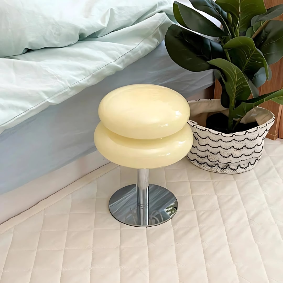 VibeCore Macarons Glass Table Lamp Cream placed beside bed, adding soft, pastel glow to a cozy bedroom setting.