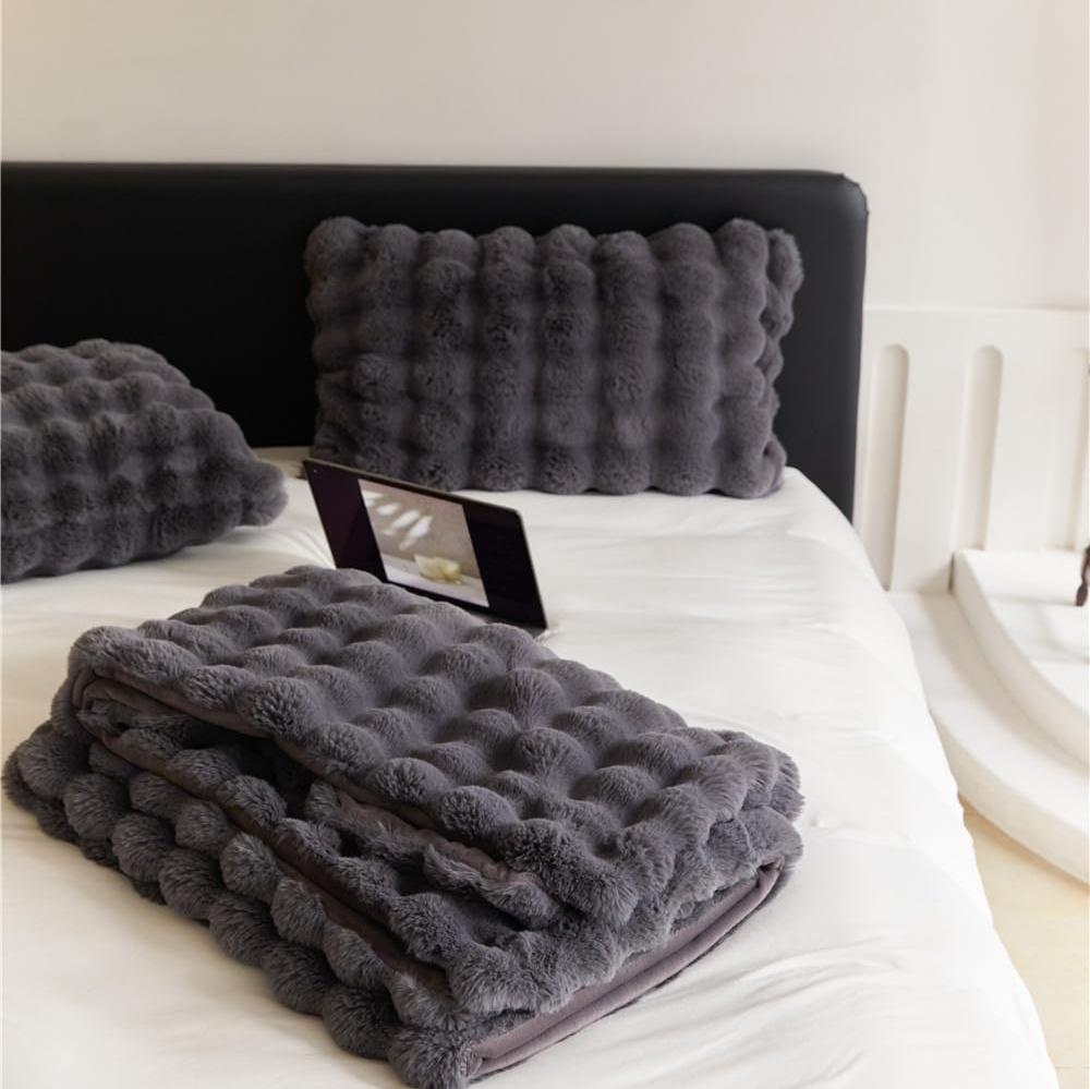 VibeCore Marshmallow Ultra Plush Blanket Black Folded On Bed, demonstrating its thickness.