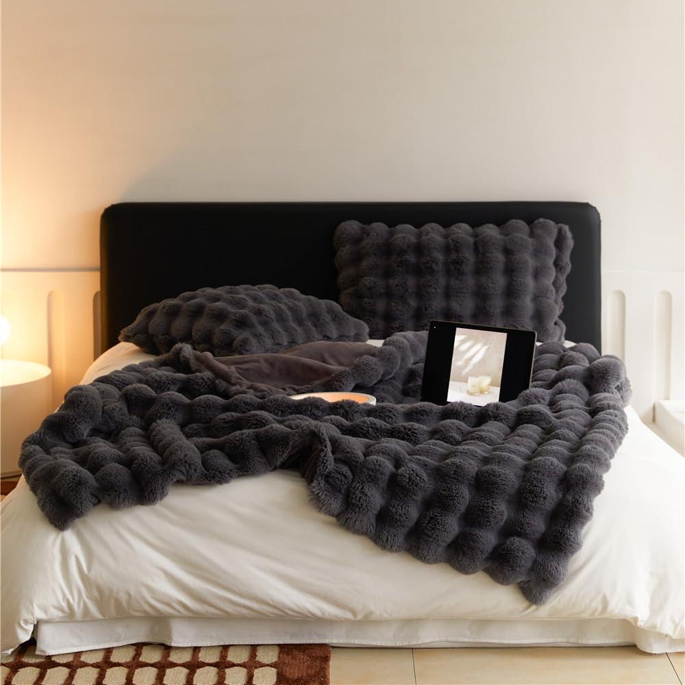 VibeCore Marshmallow Ultra Plush Blanket Black On Bed, showcasing it's luxurious and ultra cozy look in a bedroom.