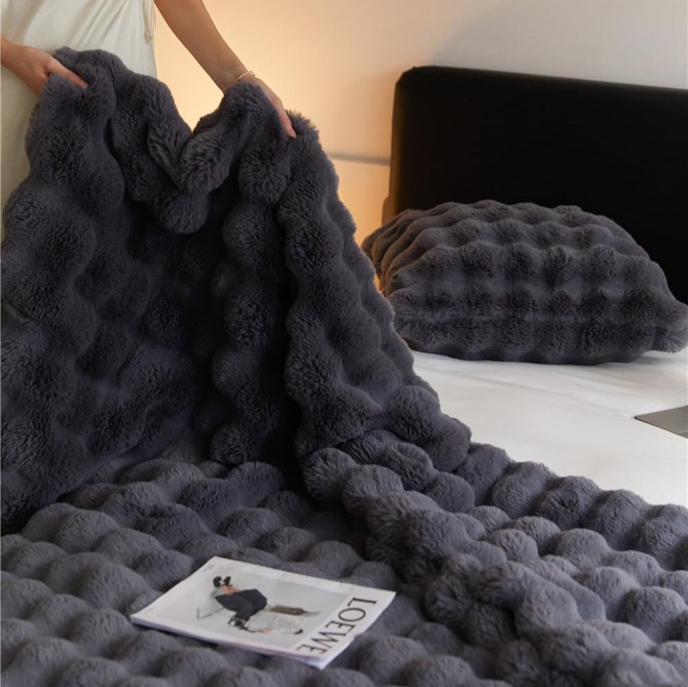 VibeCore Marshmallow Ultra Plush Blanket Black Woman Holding It, demonstrating its tufted and plush material.