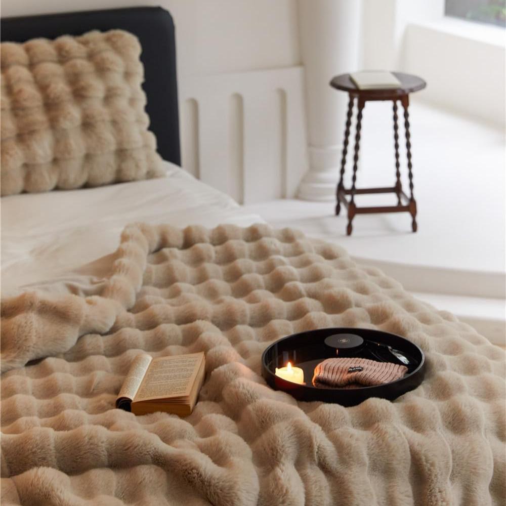 VibeCore Marshmallow Ultra Plush Blanket Khaki Close Up On Corner Of Bed, demonstrating the coziness and color.