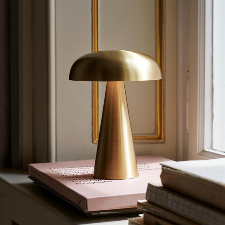 VibeCore Metal Mushroom Touch Lamp in gold, placed on a windowsill, offering a sleek, minimalist design with adjustable brightness, perfect for creating a warm ambiance in any space.