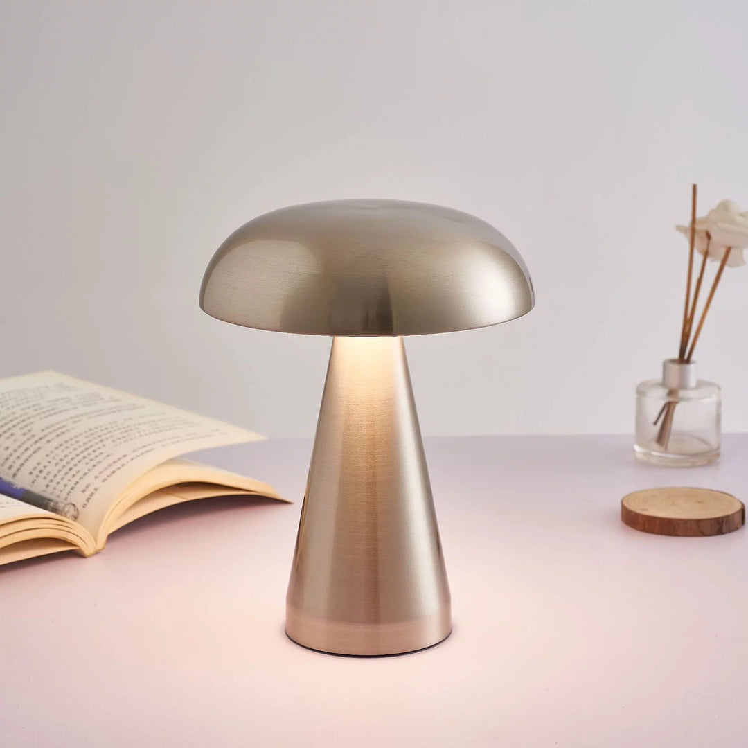 VibeCore Metal Mushroom Touch Lamp in silver, lit up on a table, casting a warm, soft glow with its sleek minimalist design, perfect for creating a cozy ambiance in modern spaces.