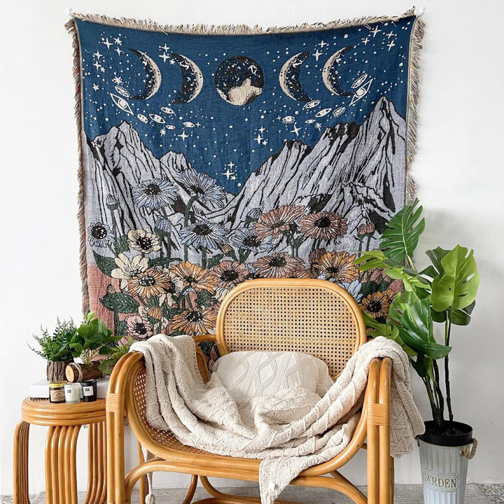 VibeCore Midnight Mountain Woven Blanket as a wall hanging, showcasing a mountain-inspired design and soft 100% combed cotton texture.
