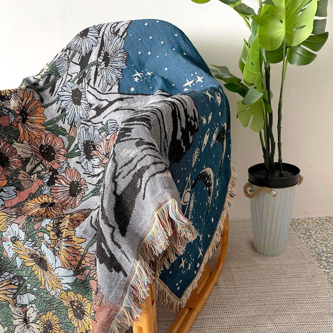 VibeCore Midnight Mountain Woven Blanket draped over chair, featuring serene mountain design and soft 100% combed cotton texture.