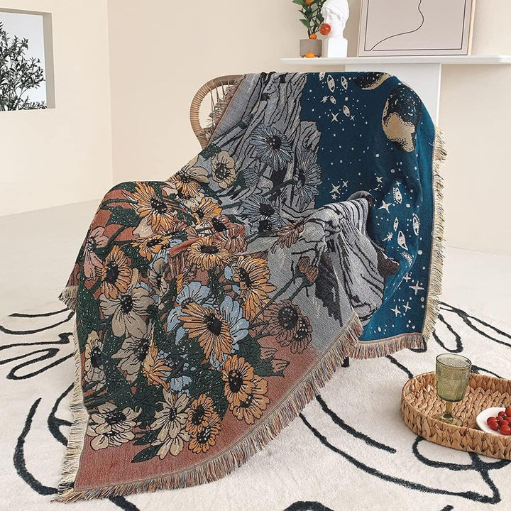 VibeCore Midnight Mountain Woven Blanket on chair, featuring a mountain-inspired design and soft 100% combed cotton fabric.
